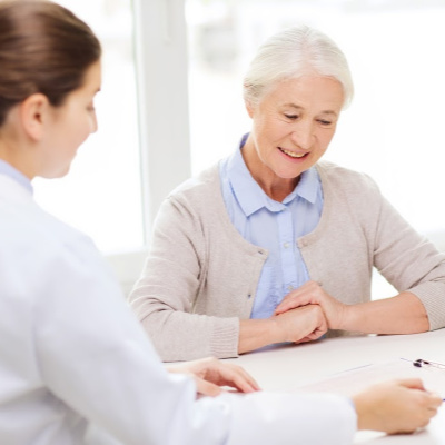 Doctor with patient helping to fill out medicare paperwork